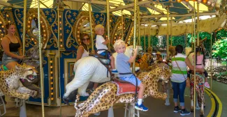 Children riding carousel.